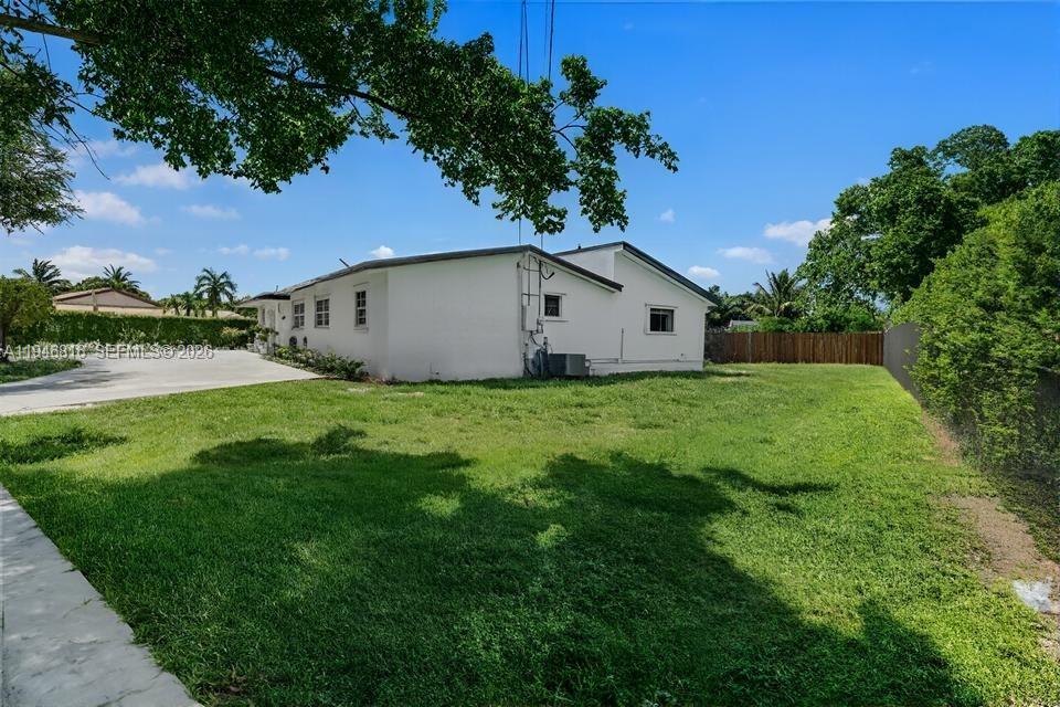 10351 Southwest 49th Street, Unit MAIN Miami, FL 33165 - Photo 3 of 21 a view of yard with small huts and green space