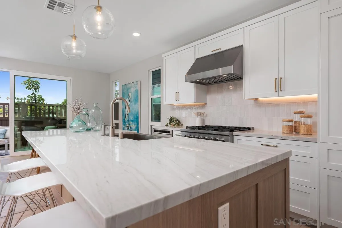 559 North Vulcan Avenue Encinitas, CA 92024 - Photo 13 of 50 a kitchen with stainless steel appliances a stove a sink and a refrigerator
