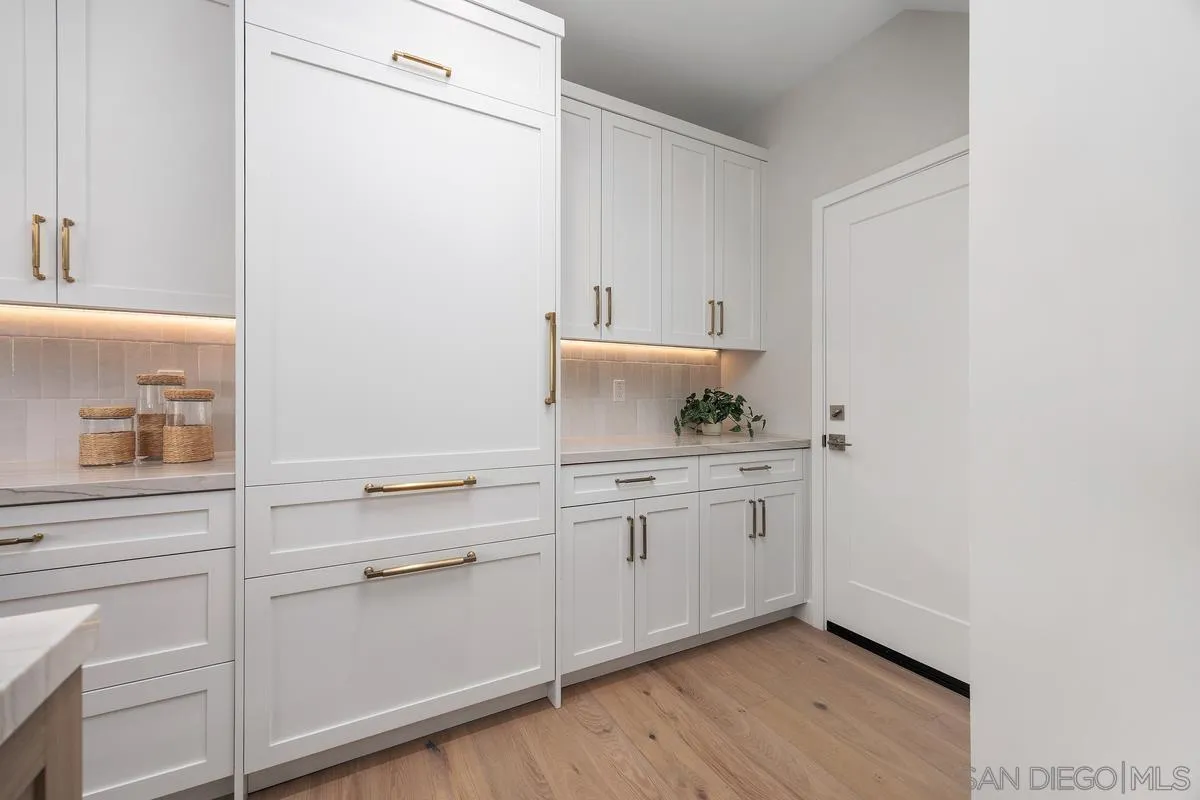 559 North Vulcan Avenue Encinitas, CA 92024 - Photo 17 of 50 a room with a sink cabinets and wooden floor