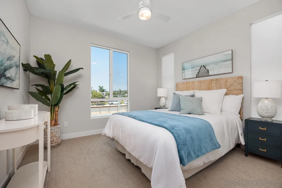 559 North Vulcan Avenue Encinitas, CA 92024 - Photo 27 of 50 a bedroom with a large bed and a potted plant
