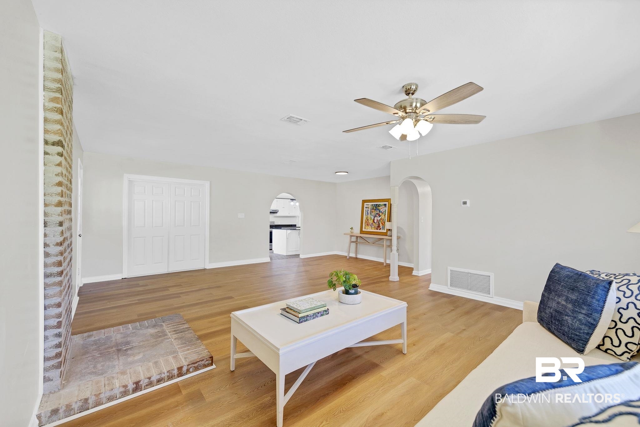 11964 Stroh Road Daphne, AL 36527 - Photo 15 of 58 Living area with visible vents, ceiling fan, arched walkways, and wood finished floors