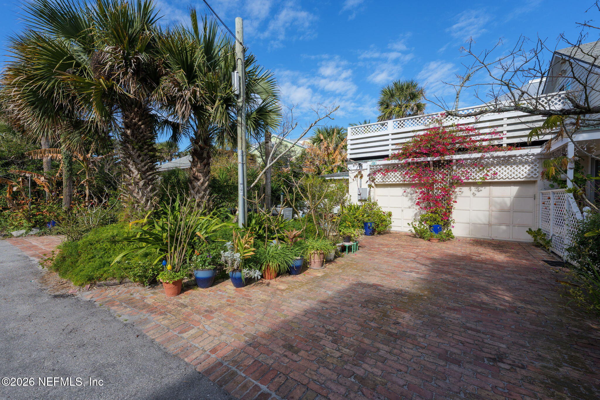 211 Beach Avenue Atlantic Beach, FL 32233 - Photo 12 of 44 a front view of a house with a yard and a garage