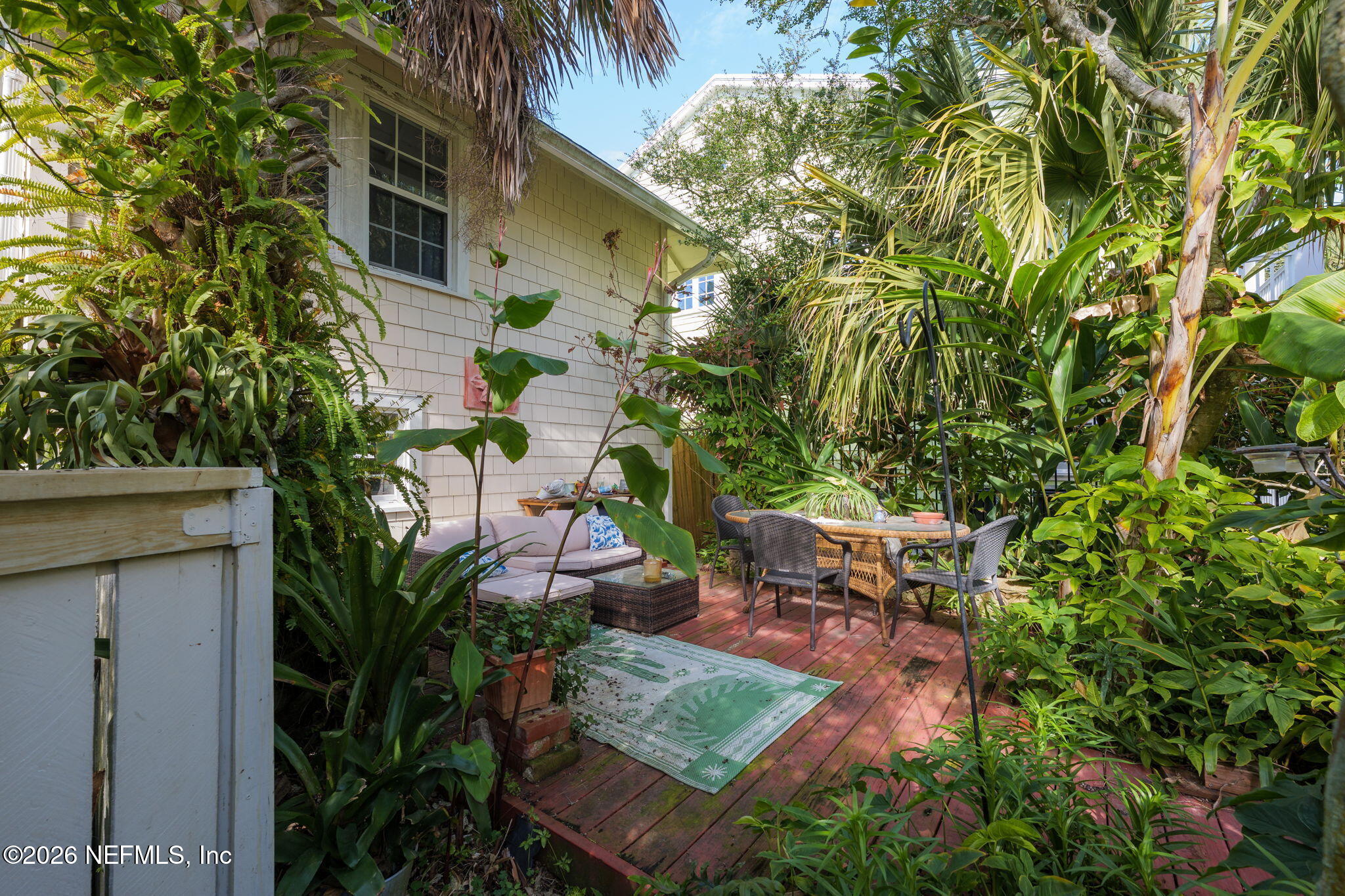 211 Beach Avenue Atlantic Beach, FL 32233 - Photo 18 of 44 a backyard of a house with outdoor seating and trees