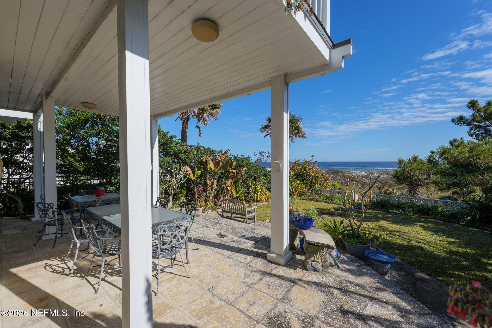 211 Beach Avenue Atlantic Beach, FL 32233 - Photo 26 of 44 a view of a patio with table and chairs and potted plants