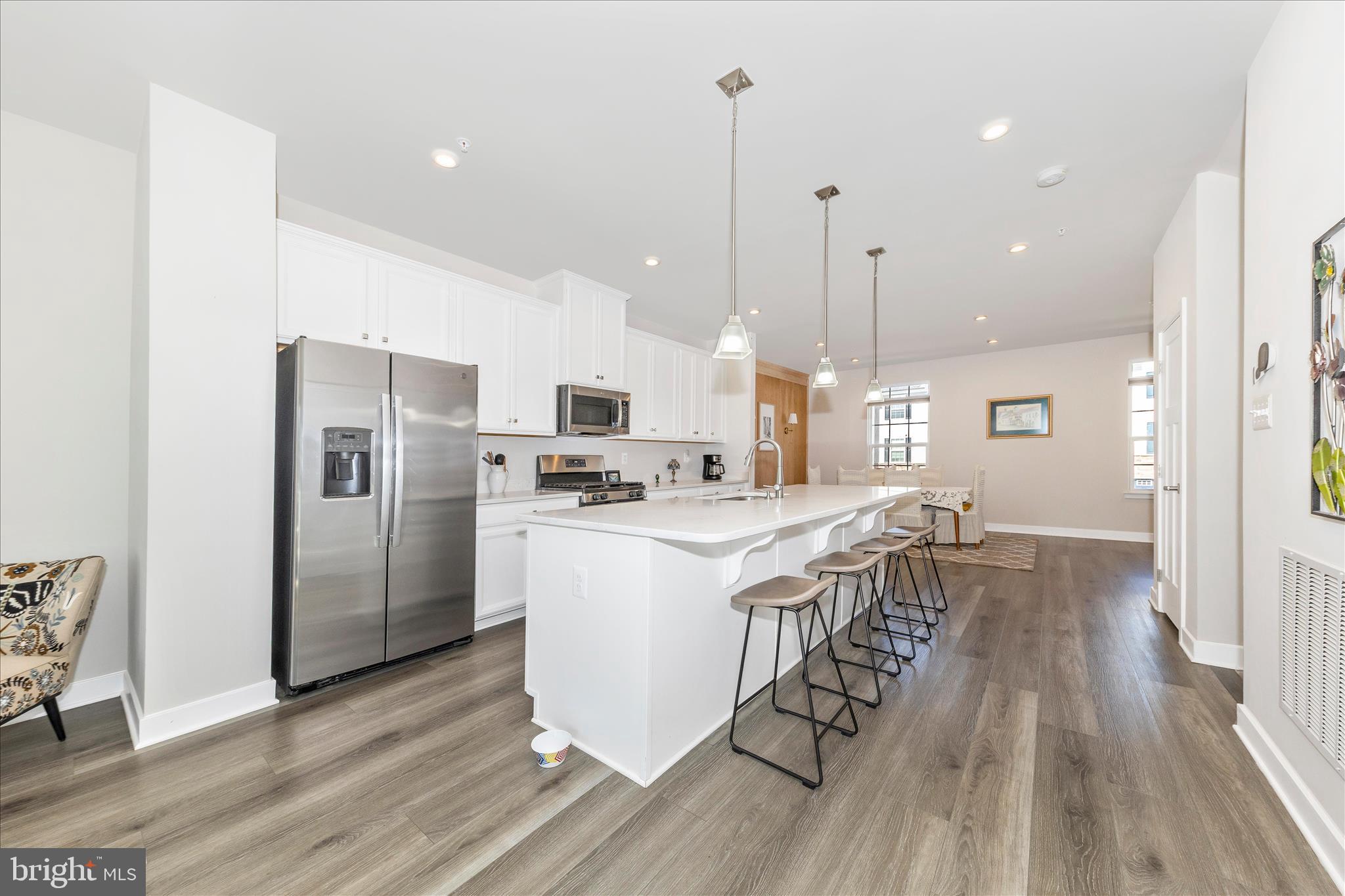 1736 Atlas Drive Frederick, MD 21702 - Photo 13 of 99 a kitchen with stainless steel appliances granite countertop a refrigerator a sink dishwasher a stove and white countertops with wooden floor