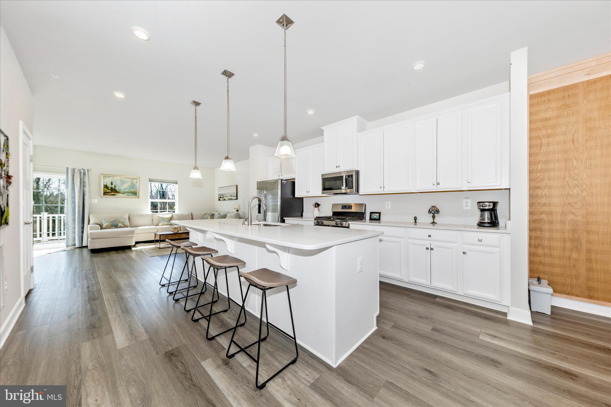 1736 Atlas Drive Frederick, MD 21702 - Photo 16 of 99 a kitchen with stainless steel appliances kitchen island hardwood floor sink and stove