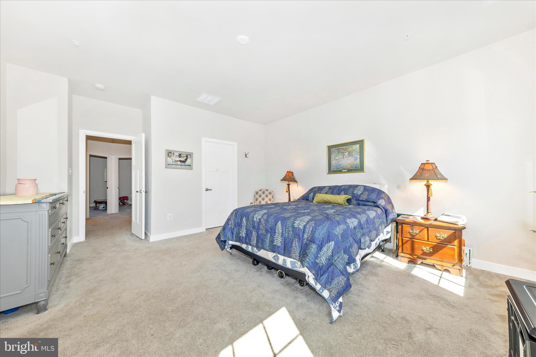 1736 Atlas Drive Frederick, MD 21702 - Photo 27 of 99 a spacious bedroom with a bed and a lamp