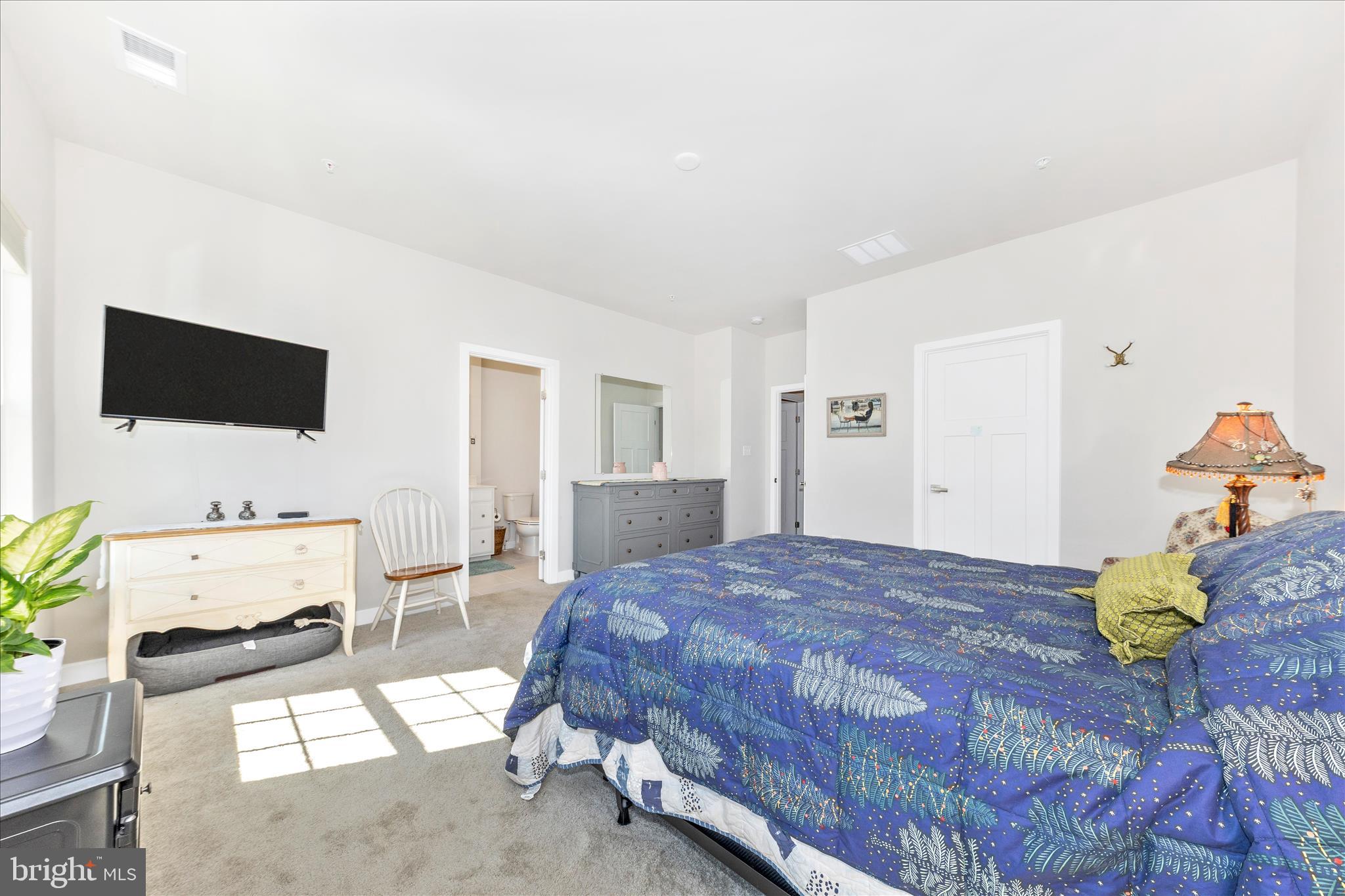 1736 Atlas Drive Frederick, MD 21702 - Photo 28 of 99 a bedroom with a bed a flat screen tv and a couch