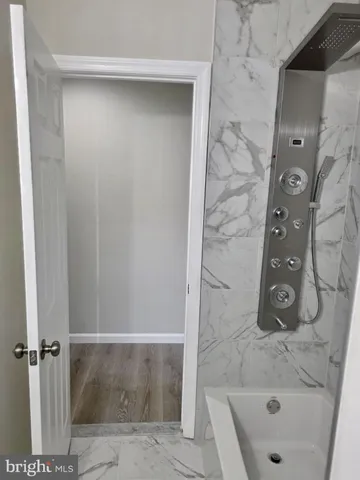 wooden bathroom with a bathtub