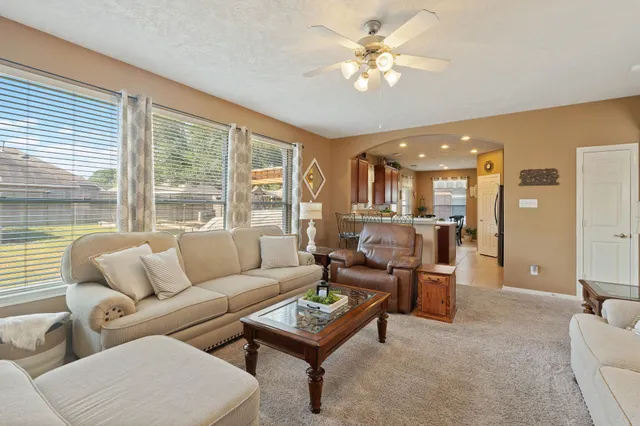 a living room with furniture and a large window
