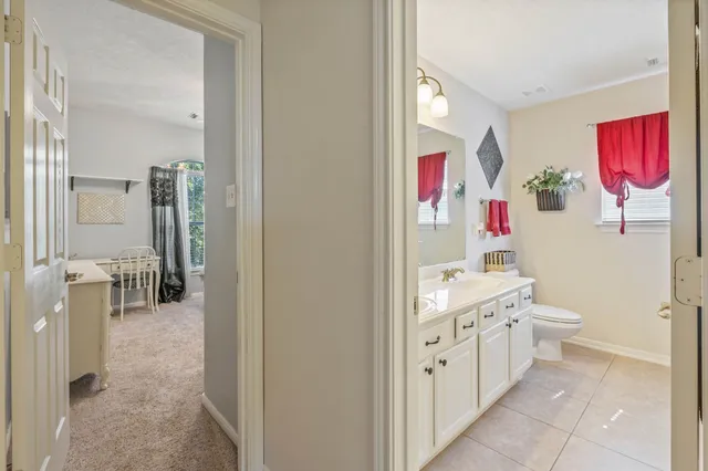 a bathroom with a sink mirror vanity and toilet