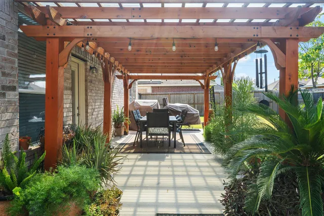 a view of a porch with chairs and potted plants