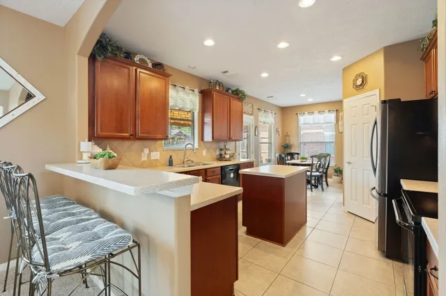 a kitchen with a sink a counter top space cabinets and stainless steel appliances