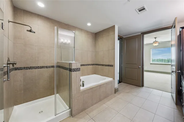 a bathroom with a tub and shower