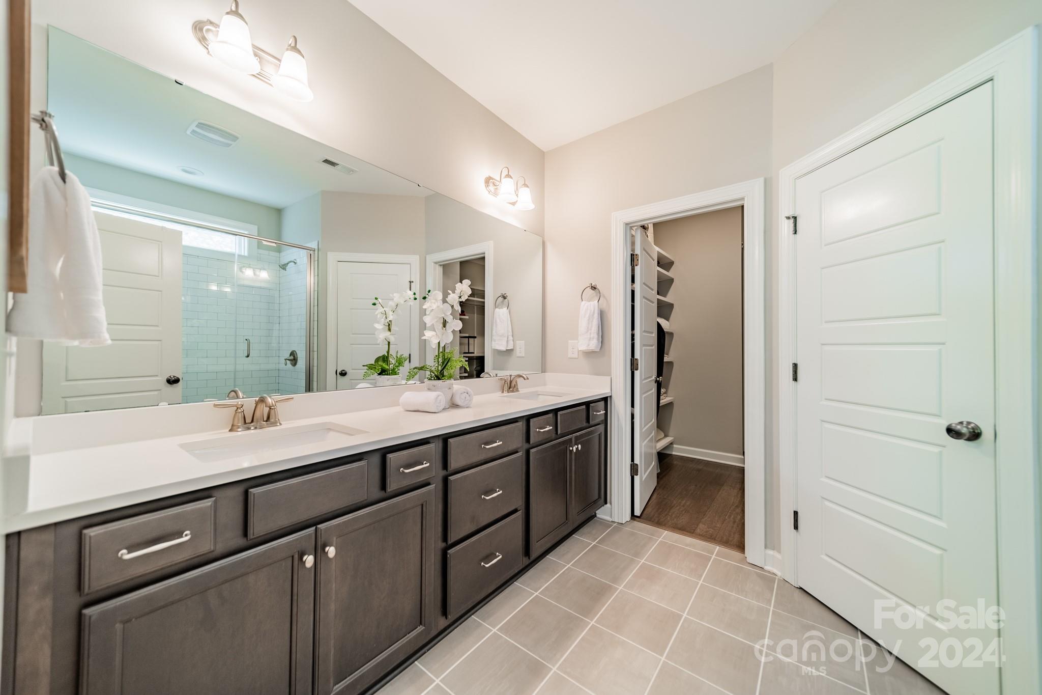 2826 Walker Road Matthews, NC 28105 - Photo 30 of 45 a spacious bathroom with a shower sink and mirror