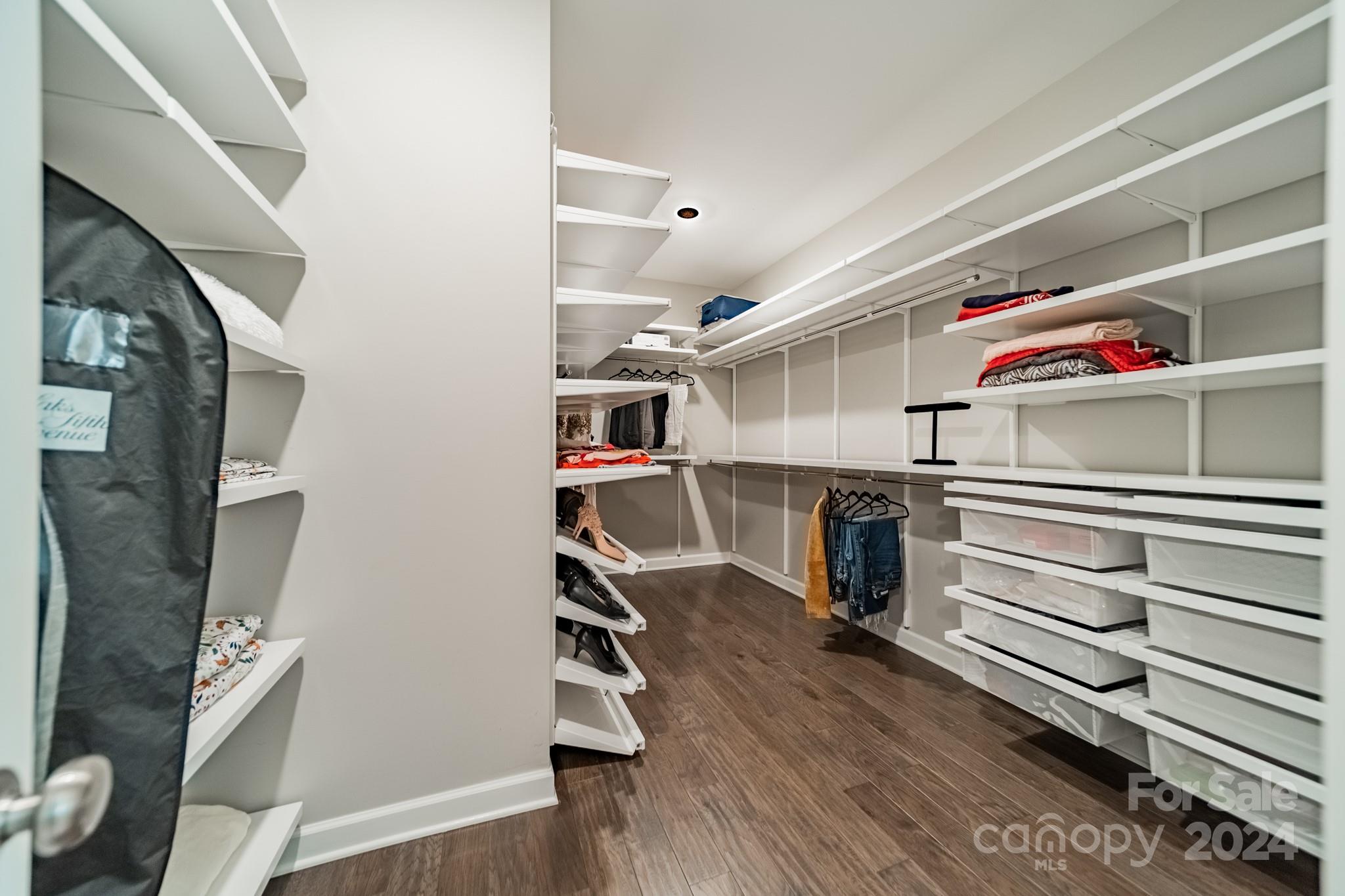 2826 Walker Road Matthews, NC 28105 - Photo 32 of 45 a view of walk in closet with clothes and shoes
