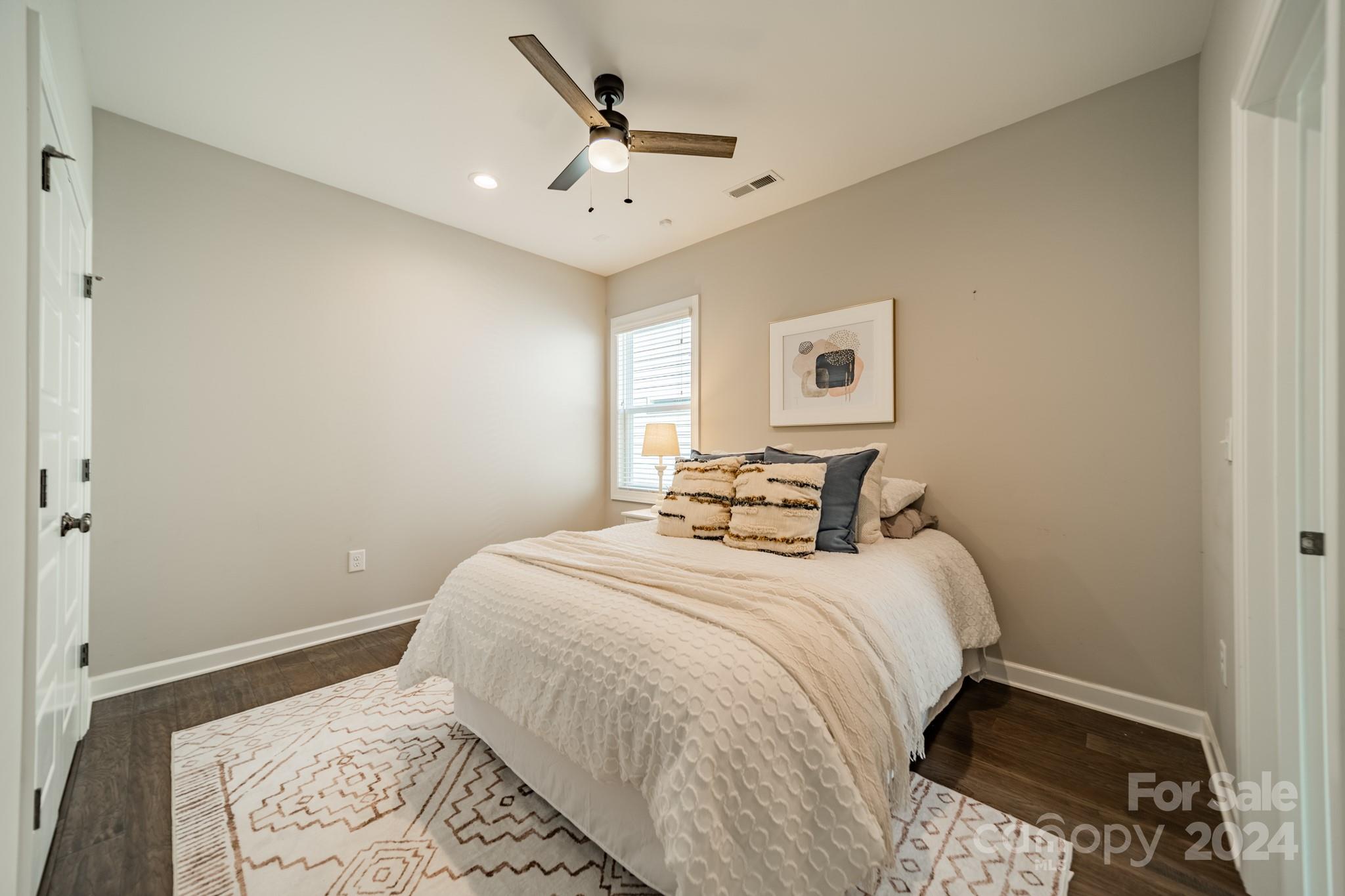 2826 Walker Road Matthews, NC 28105 - Photo 35 of 45 a bedroom with a large bed and a chandelier