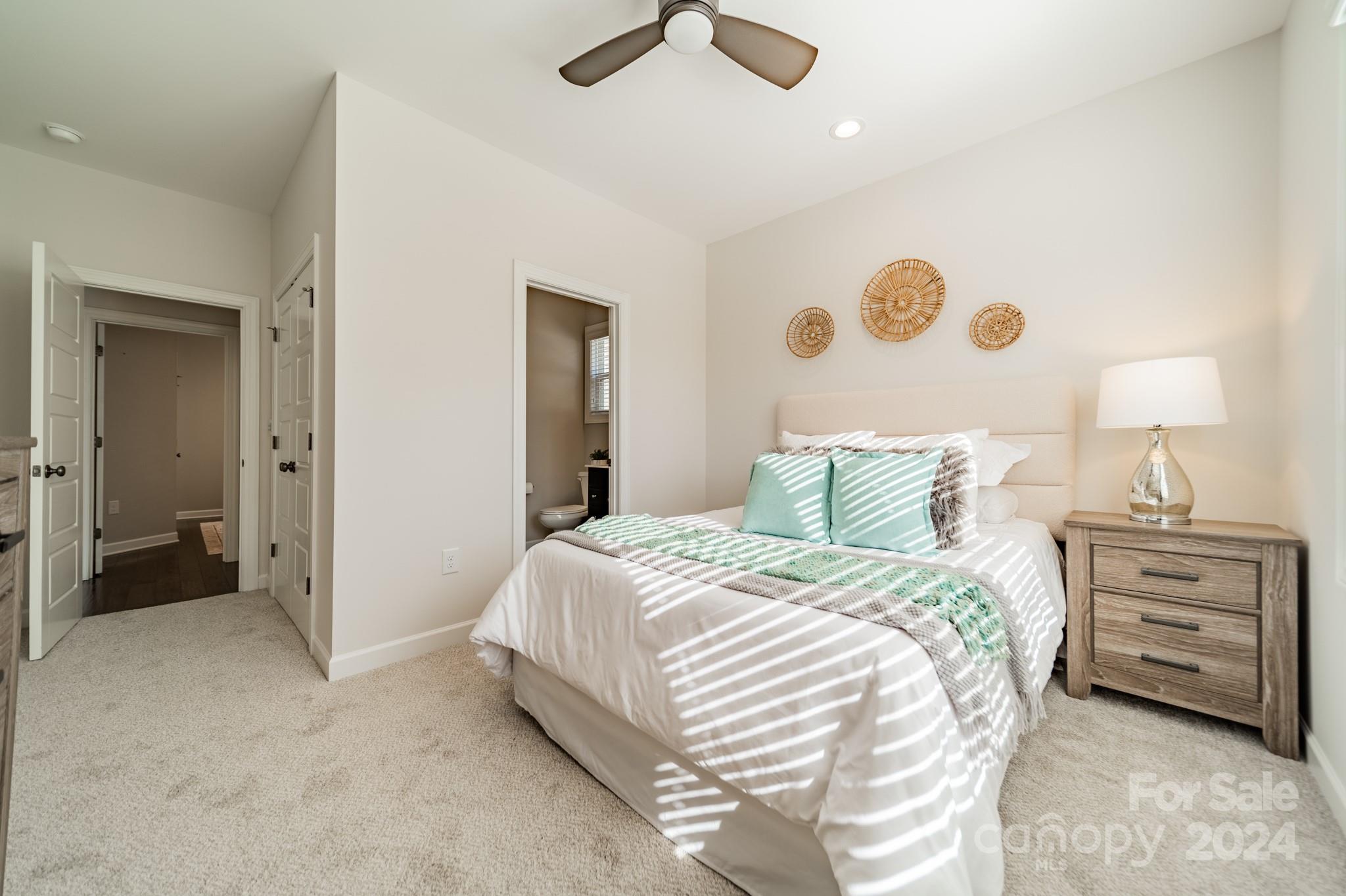 2826 Walker Road Matthews, NC 28105 - Photo 40 of 45 a bedroom with a bed and a chandelier