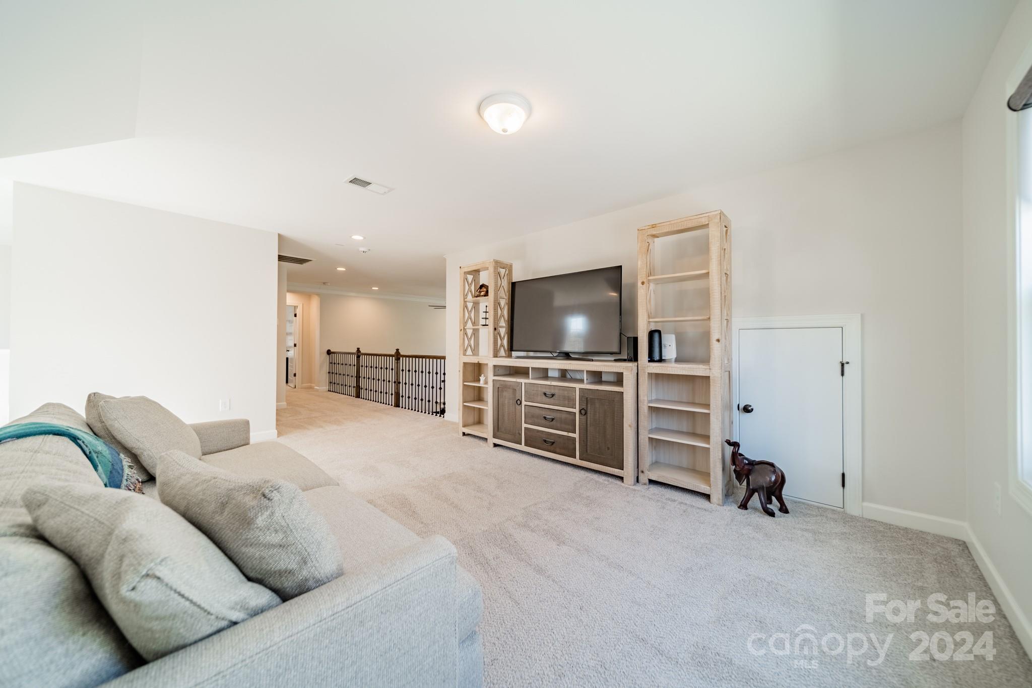 2826 Walker Road Matthews, NC 28105 - Photo 42 of 45 a living room with furniture and a flat screen tv