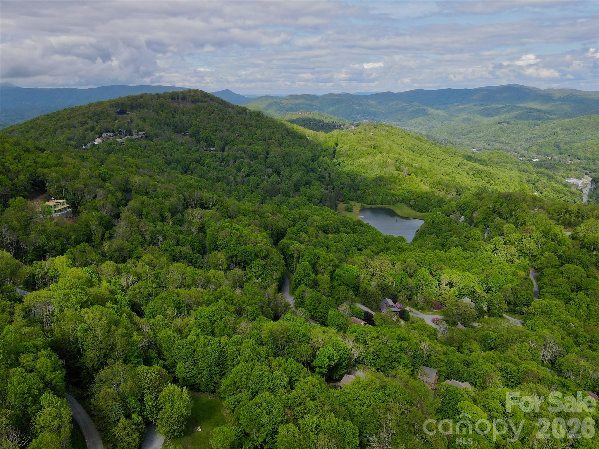 Seven Alpine Drive, Unit 33 Banner Elk, NC 28604 - Photo 3 of 8 a view of a lush green outdoor space with a swimming pool and valleys in the background