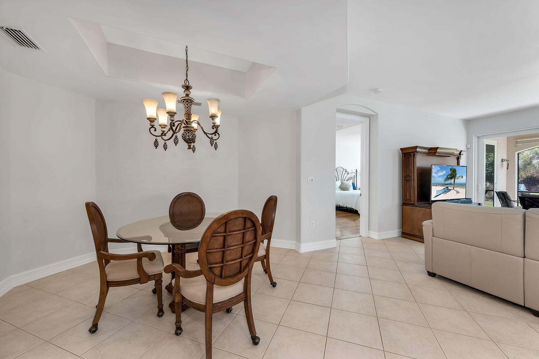 1285 Rialto Way, Unit 102 Naples, FL 34114 - Photo 11 of 49 a view of a dining room with furniture and chandelier