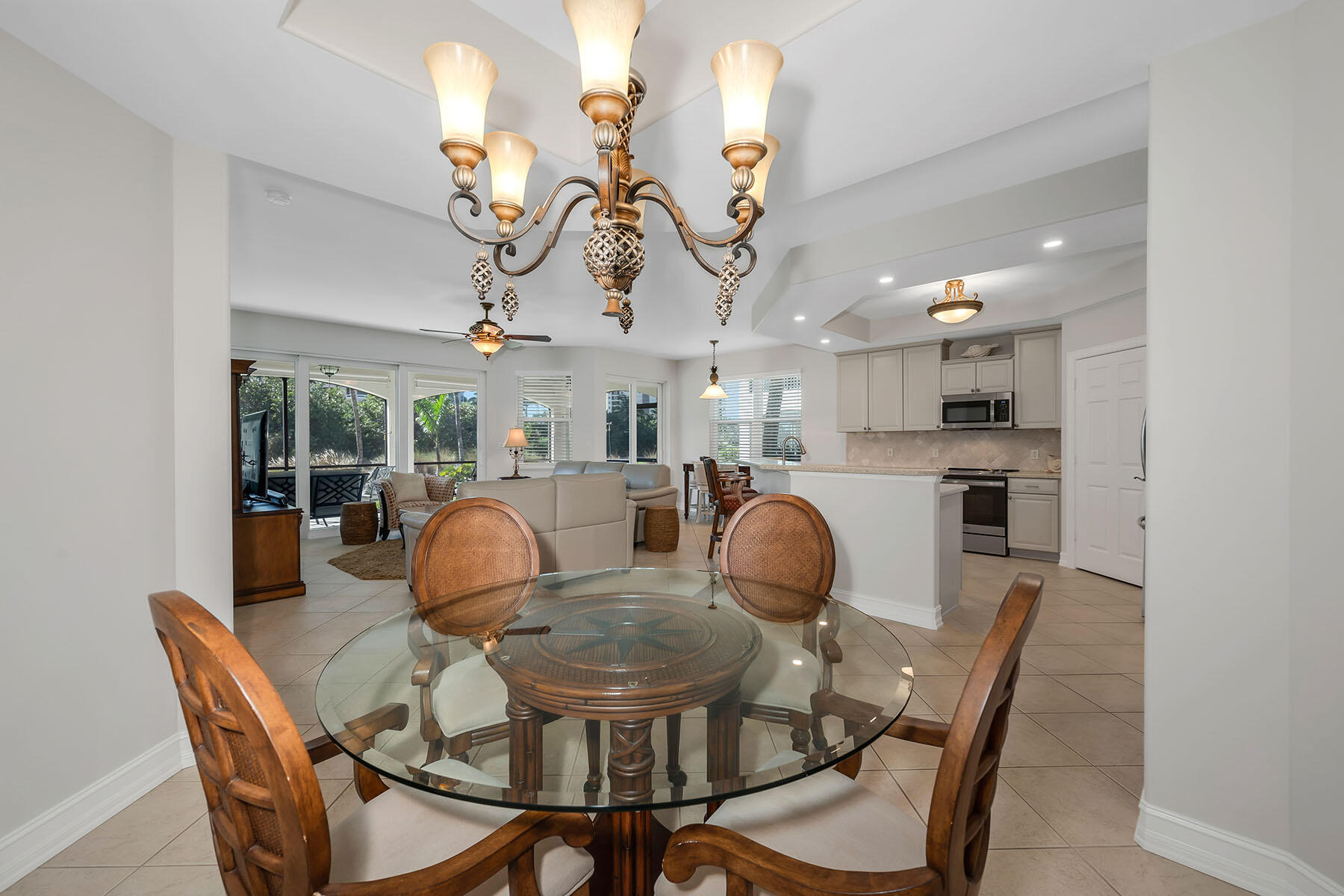 1285 Rialto Way, Unit 102 Naples, FL 34114 - Photo 13 of 49 a view of a dining room with furniture and wooden floor