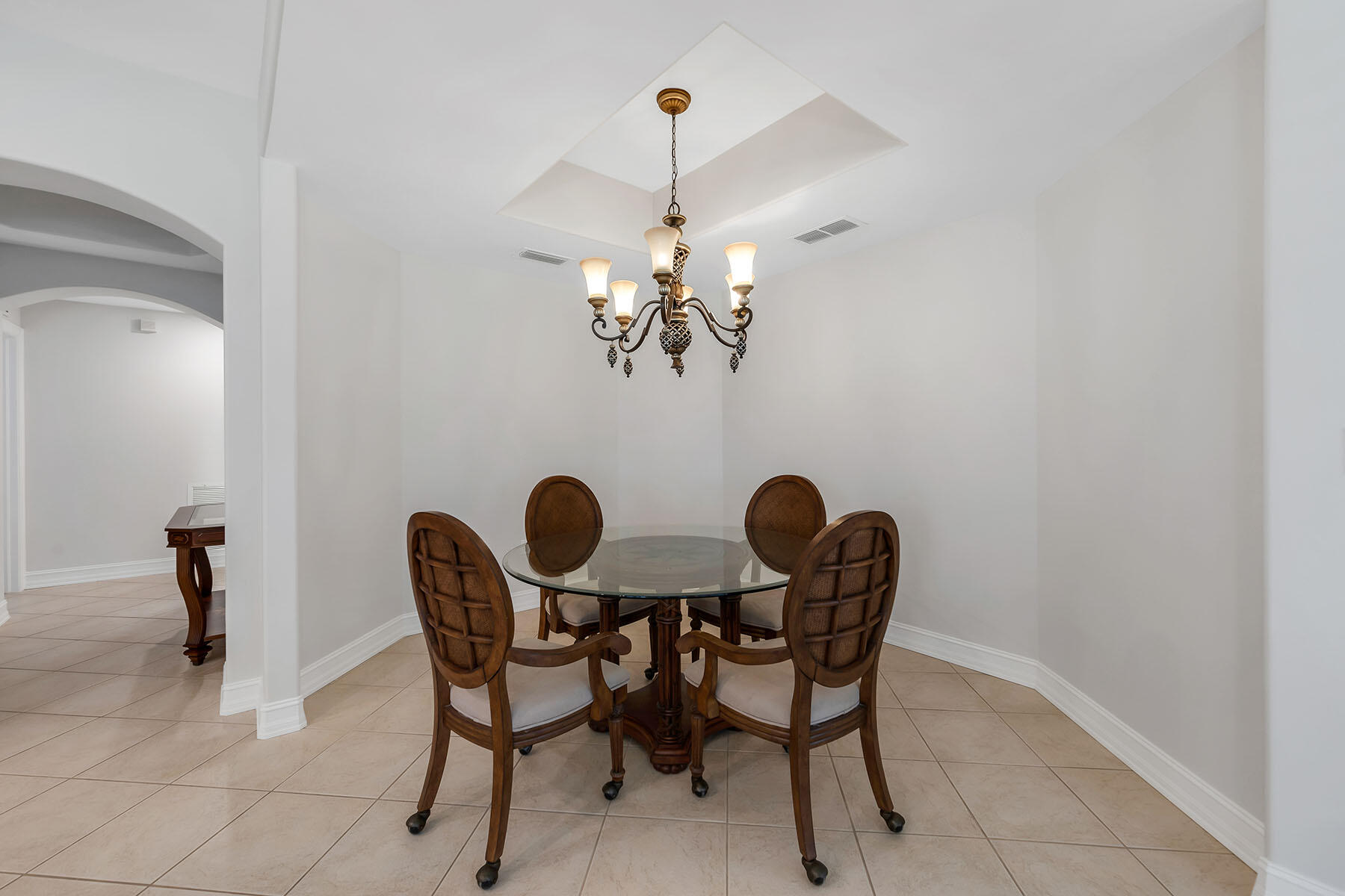 1285 Rialto Way, Unit 102 Naples, FL 34114 - Photo 14 of 49 a view of a dining room with furniture and chandelier