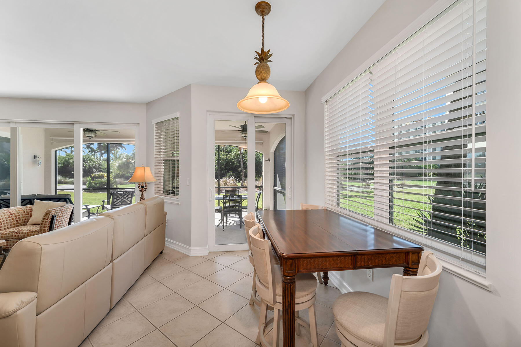1285 Rialto Way, Unit 102 Naples, FL 34114 - Photo 15 of 49 a living room with furniture and a window