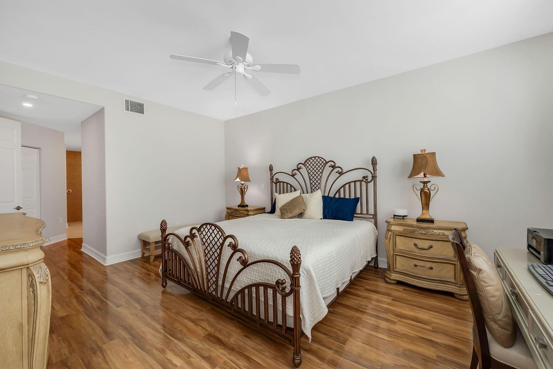 1285 Rialto Way, Unit 102 Naples, FL 34114 - Photo 17 of 49 a bedroom with a bed and wooden floor