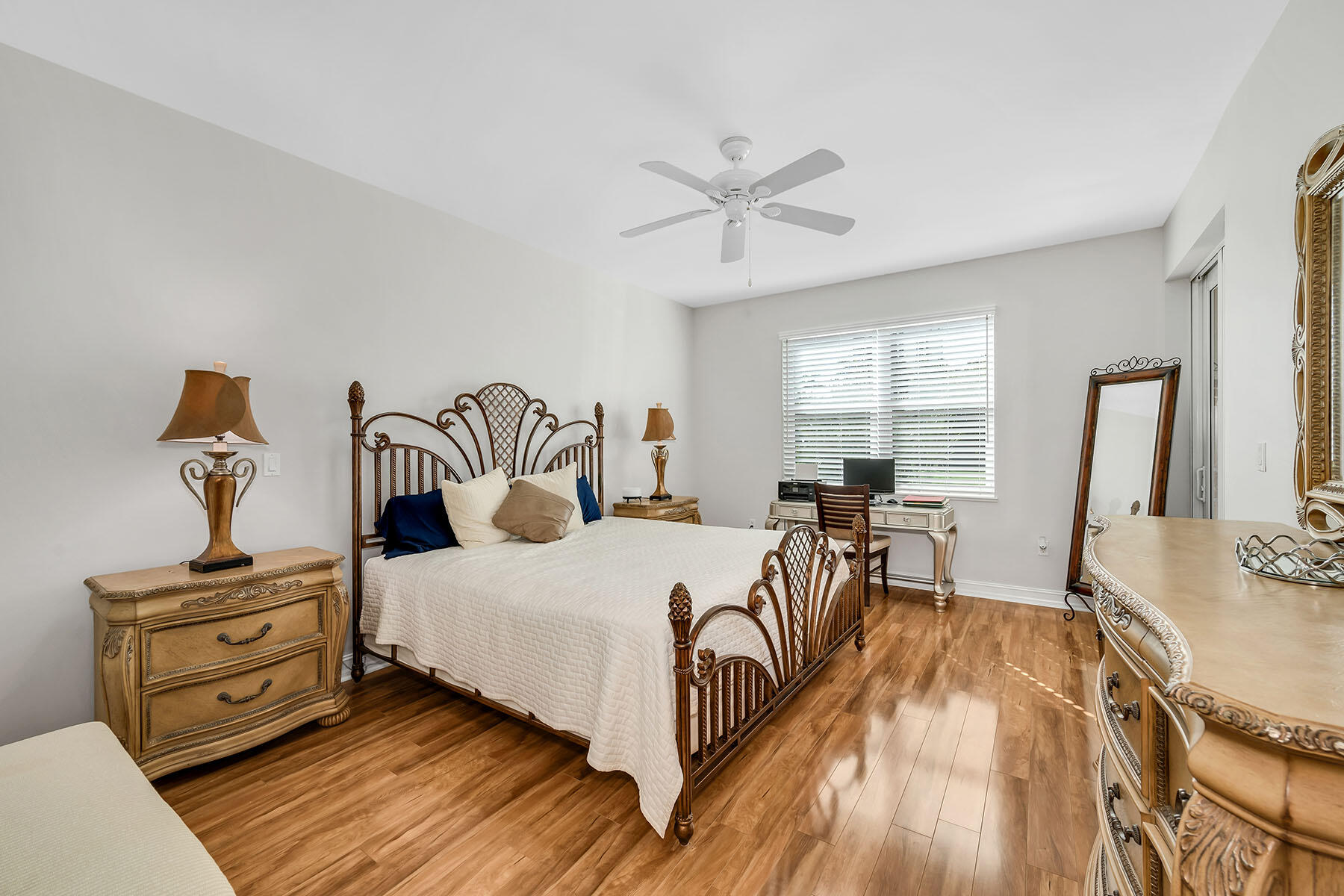 1285 Rialto Way, Unit 102 Naples, FL 34114 - Photo 18 of 49 a bedroom with a bed and wooden floor