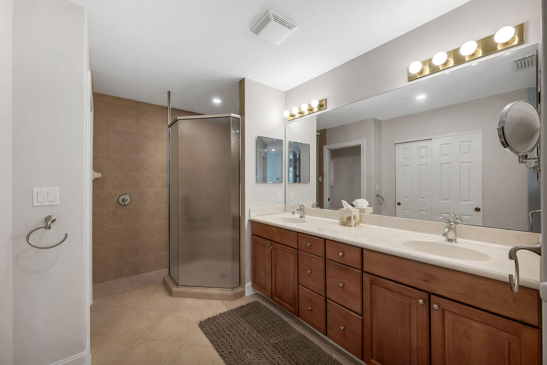 1285 Rialto Way, Unit 102 Naples, FL 34114 - Photo 19 of 49 a bathroom with a double vanity sink mirror and double