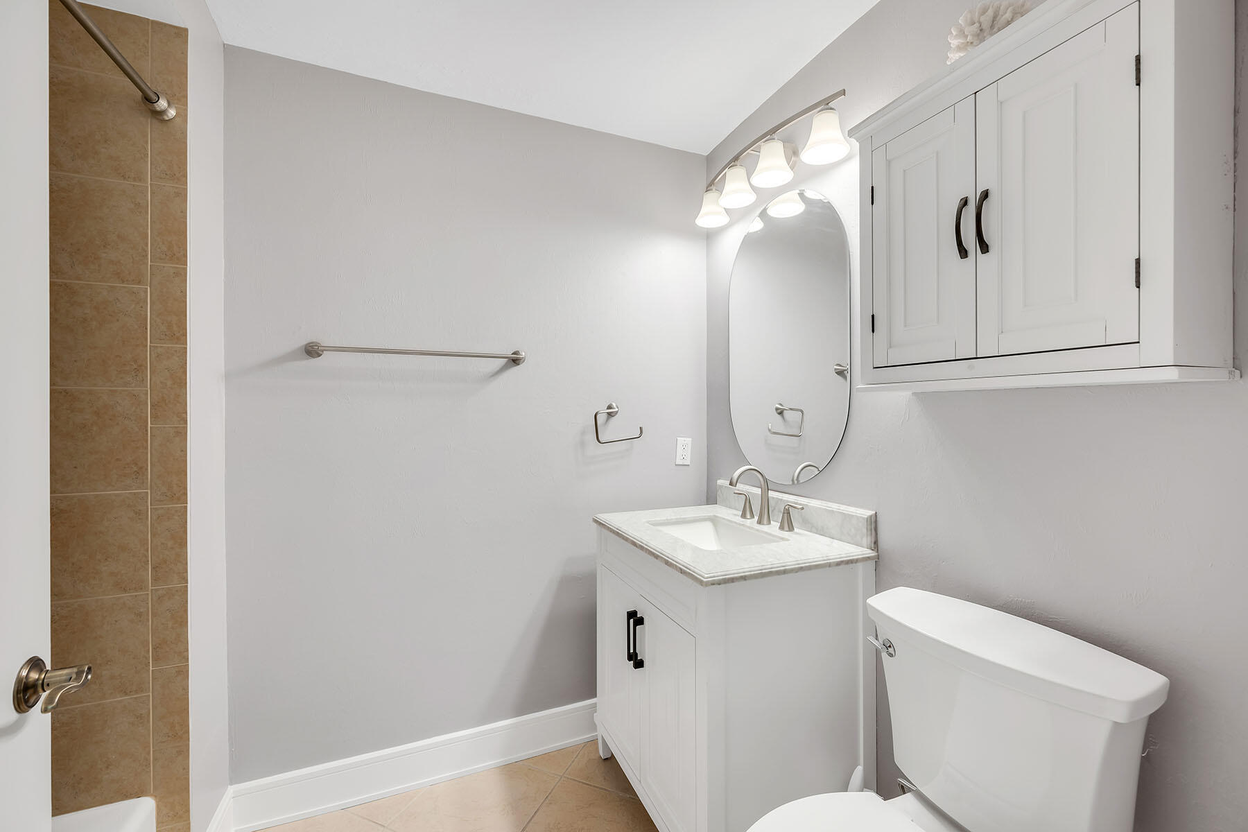 1285 Rialto Way, Unit 102 Naples, FL 34114 - Photo 22 of 49 a bathroom with a sink and mirror with toilet