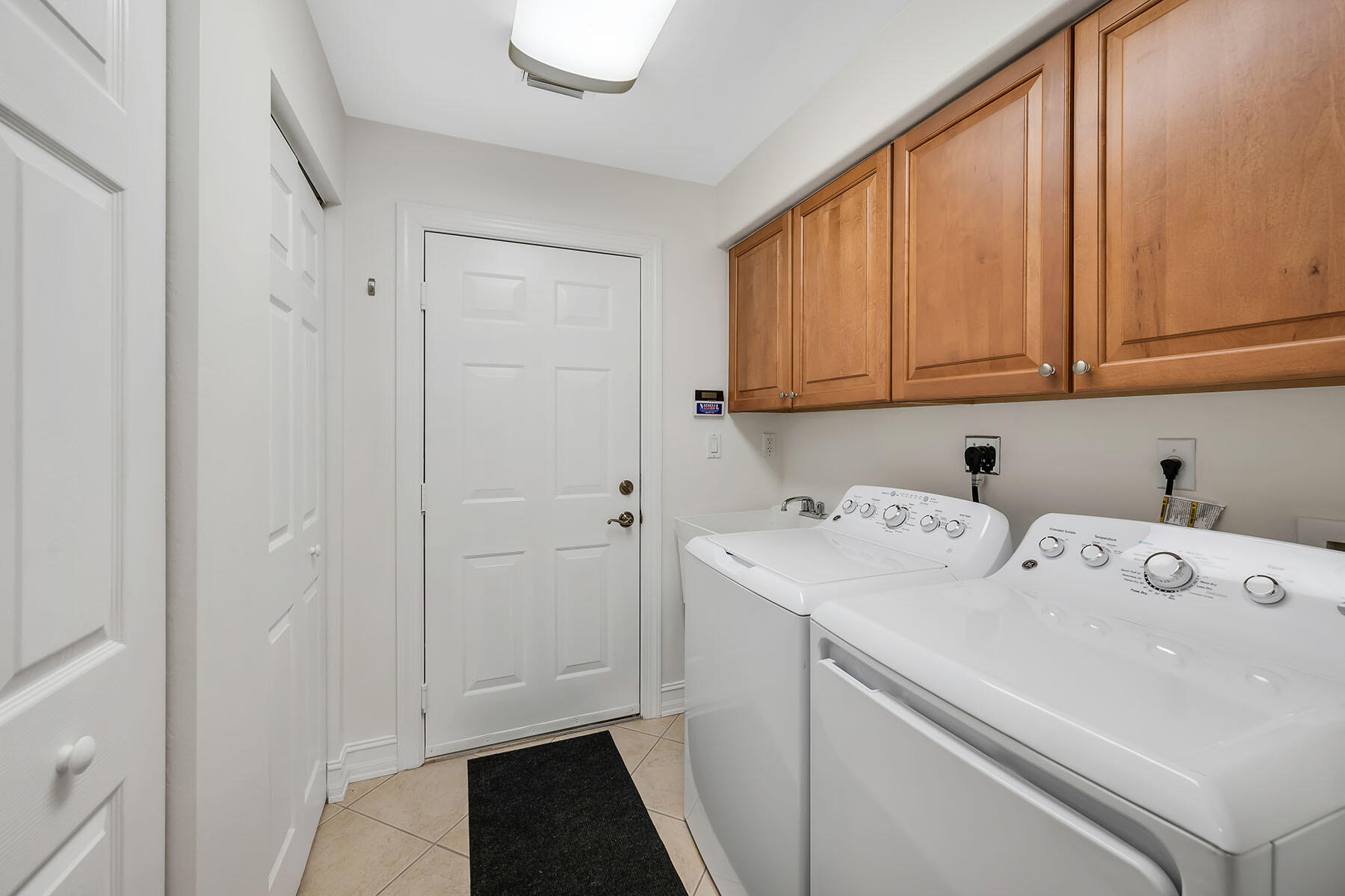 1285 Rialto Way, Unit 102 Naples, FL 34114 - Photo 25 of 49 a utility room with dryer and washer