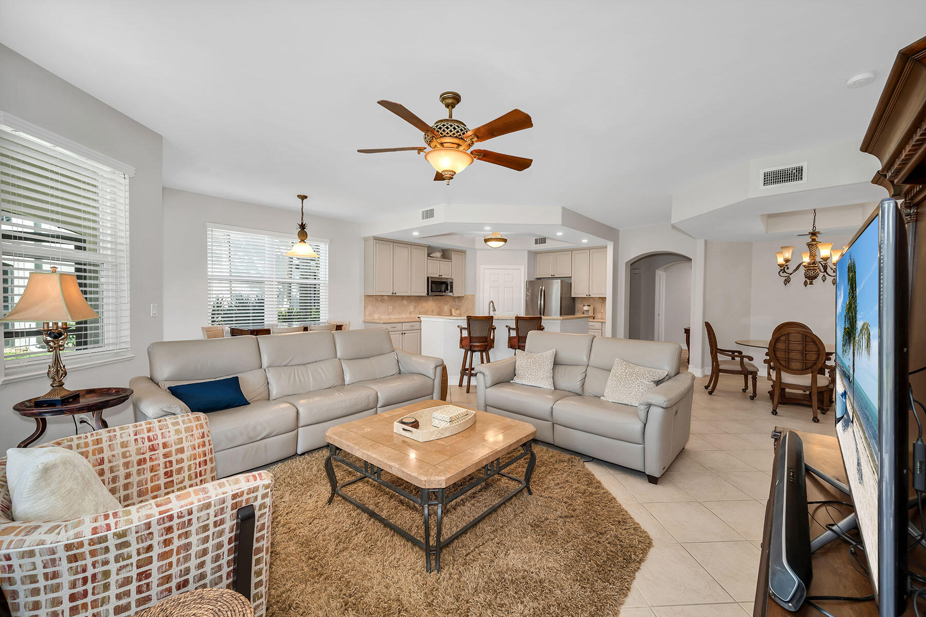 1285 Rialto Way, Unit 102 Naples, FL 34114 - Photo 3 of 49 a living room with furniture a rug and a large window