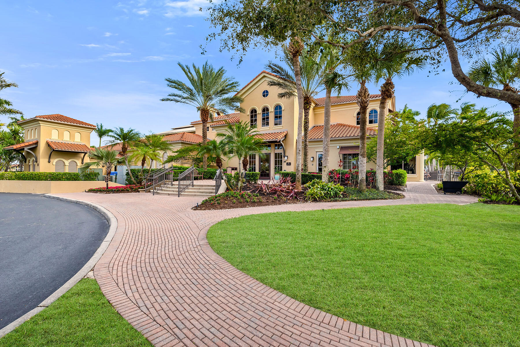 1285 Rialto Way, Unit 102 Naples, FL 34114 - Photo 33 of 49 a front view of a multi story residential apartment building with yard and green space