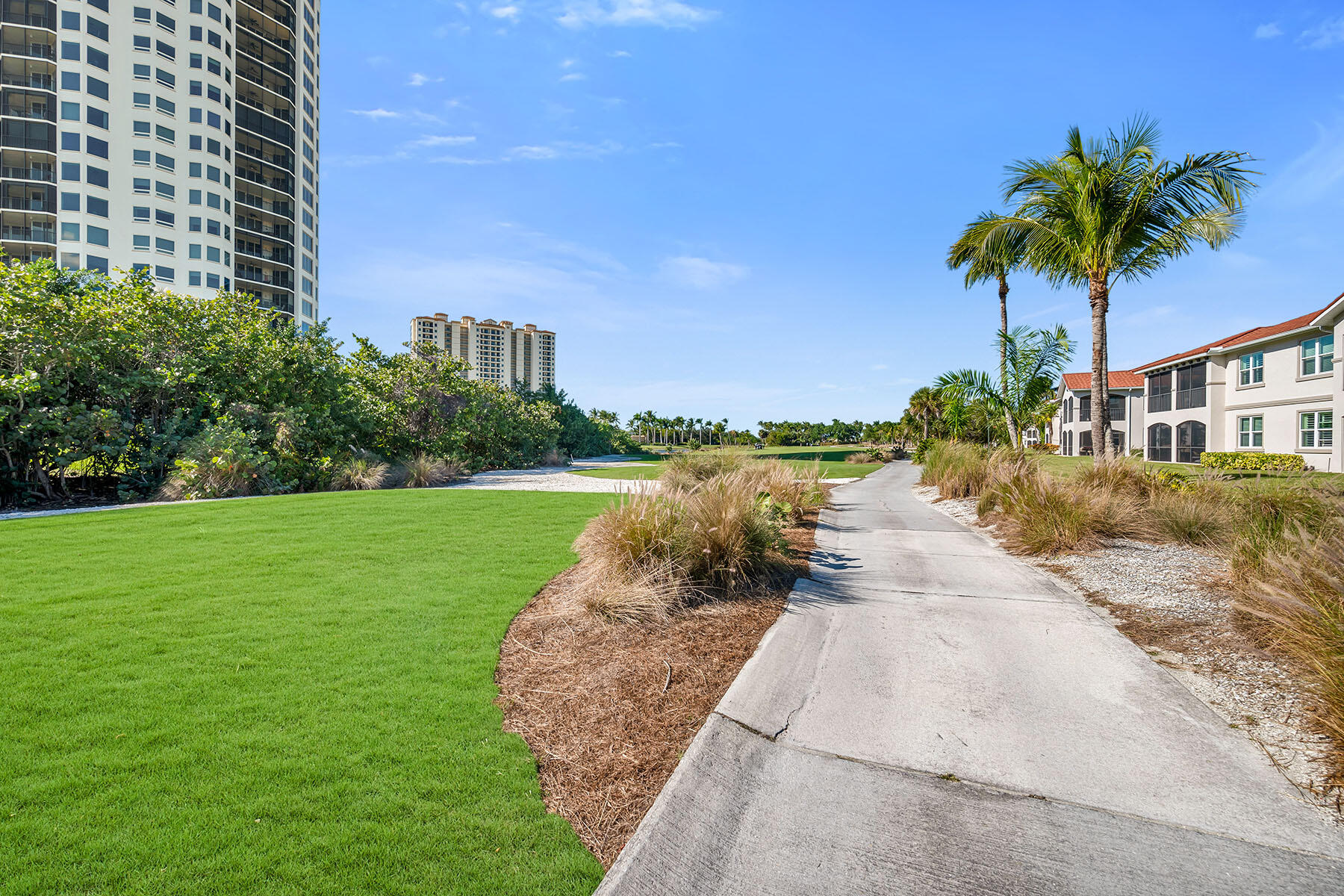 1285 Rialto Way, Unit 102 Naples, FL 34114 - Photo 37 of 49 a view of a house with a yard and potted plants