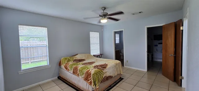 a bedroom with a bed and window