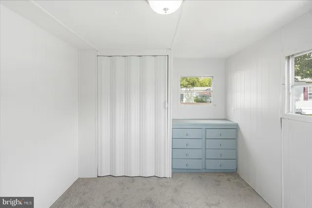 a view of a room with wooden floor and window