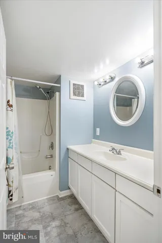 a view of a kitchen with a sink and a refrigerator