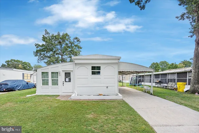 a view of a house with a backyard porch and sitting area