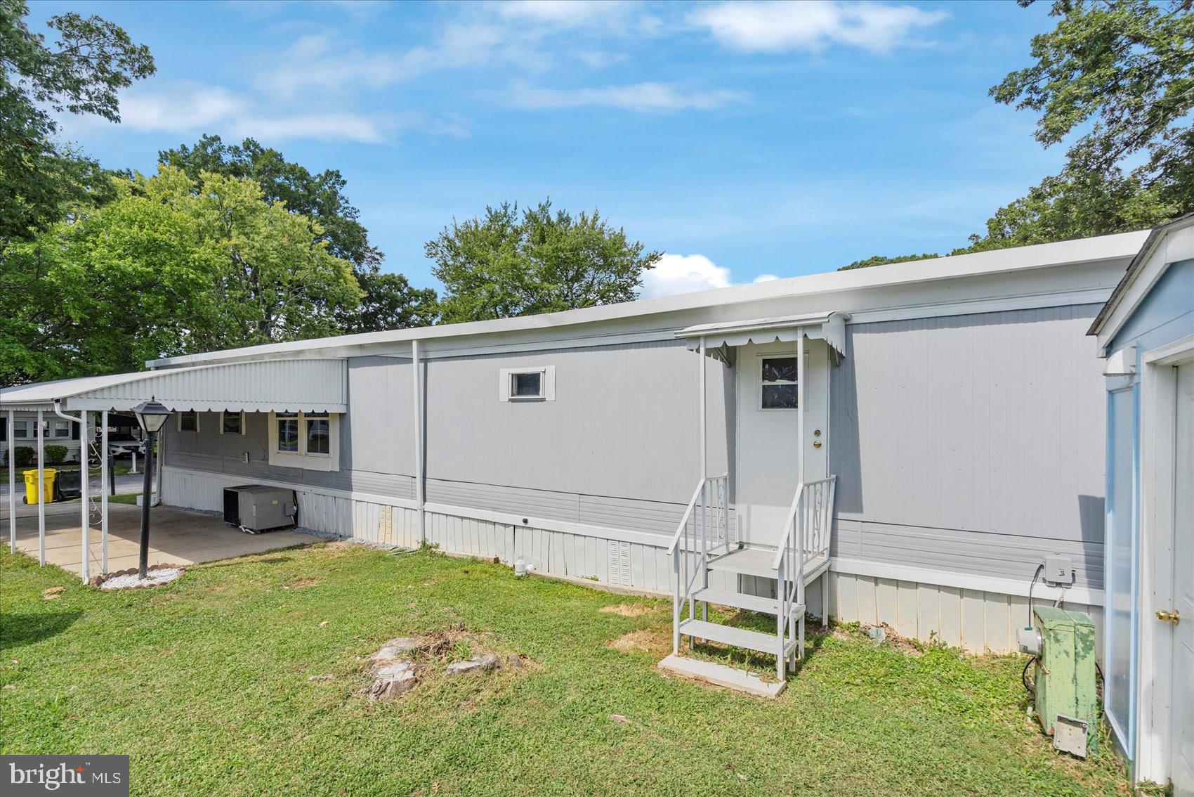 103 Conestoga Road Middle River, MD 21220 - Photo 10 of 27 Charming mobile home with lush greenery.