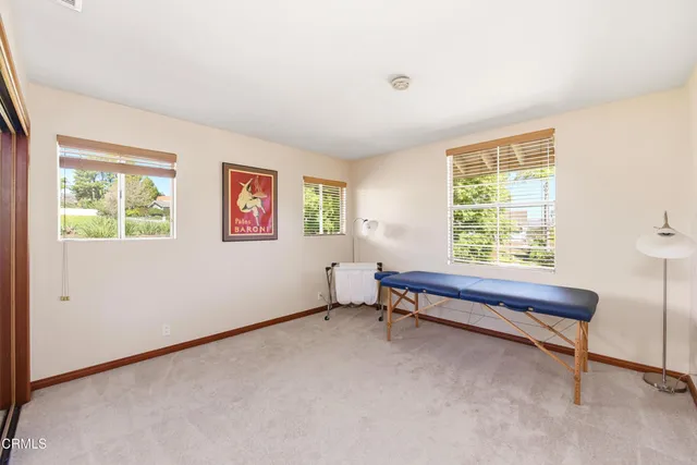 a bedroom with furniture and windows