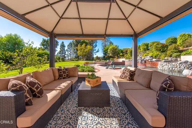 a building outdoor space with patio furniture and potted plants