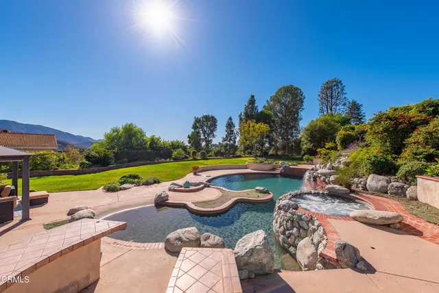 a view of a swimming pool and lounge chairs