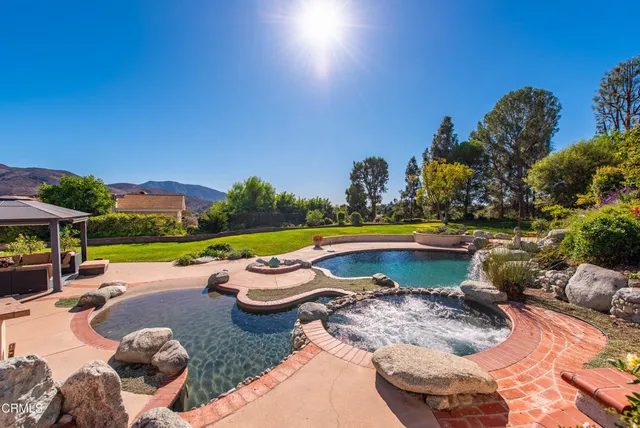 a view of swimming pool with outdoor seating and plants