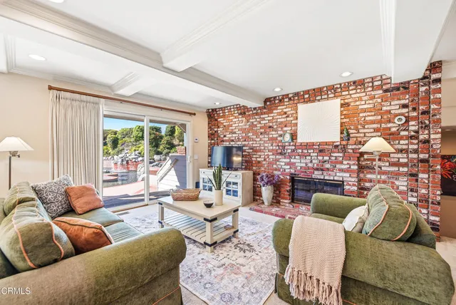 a living room with furniture and a floor to ceiling window