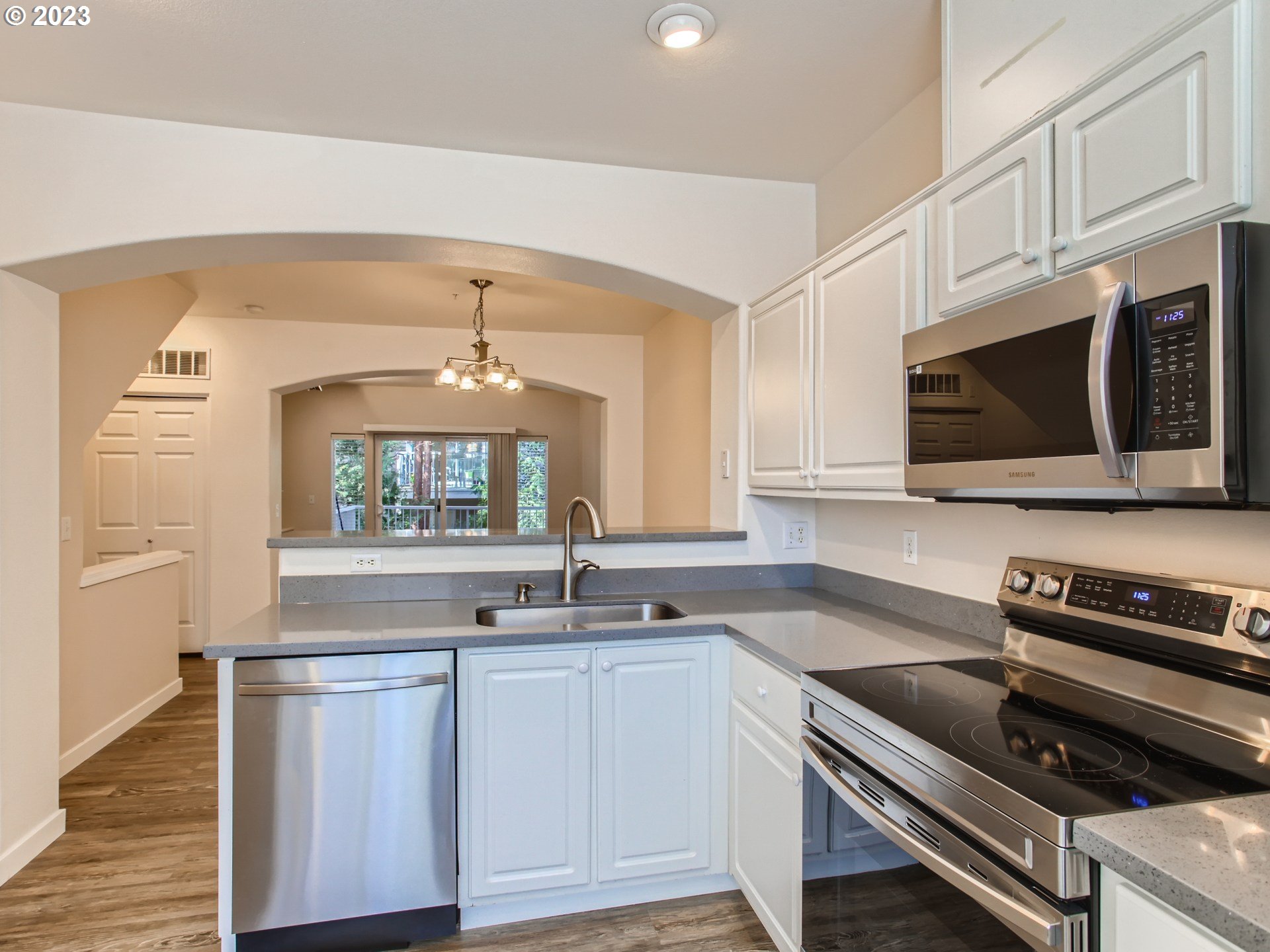 14140 Southwest Barrows Road, Unit 2 Portland, OR 97223 - Photo 11 of 30 a kitchen with a sink stove and microwave