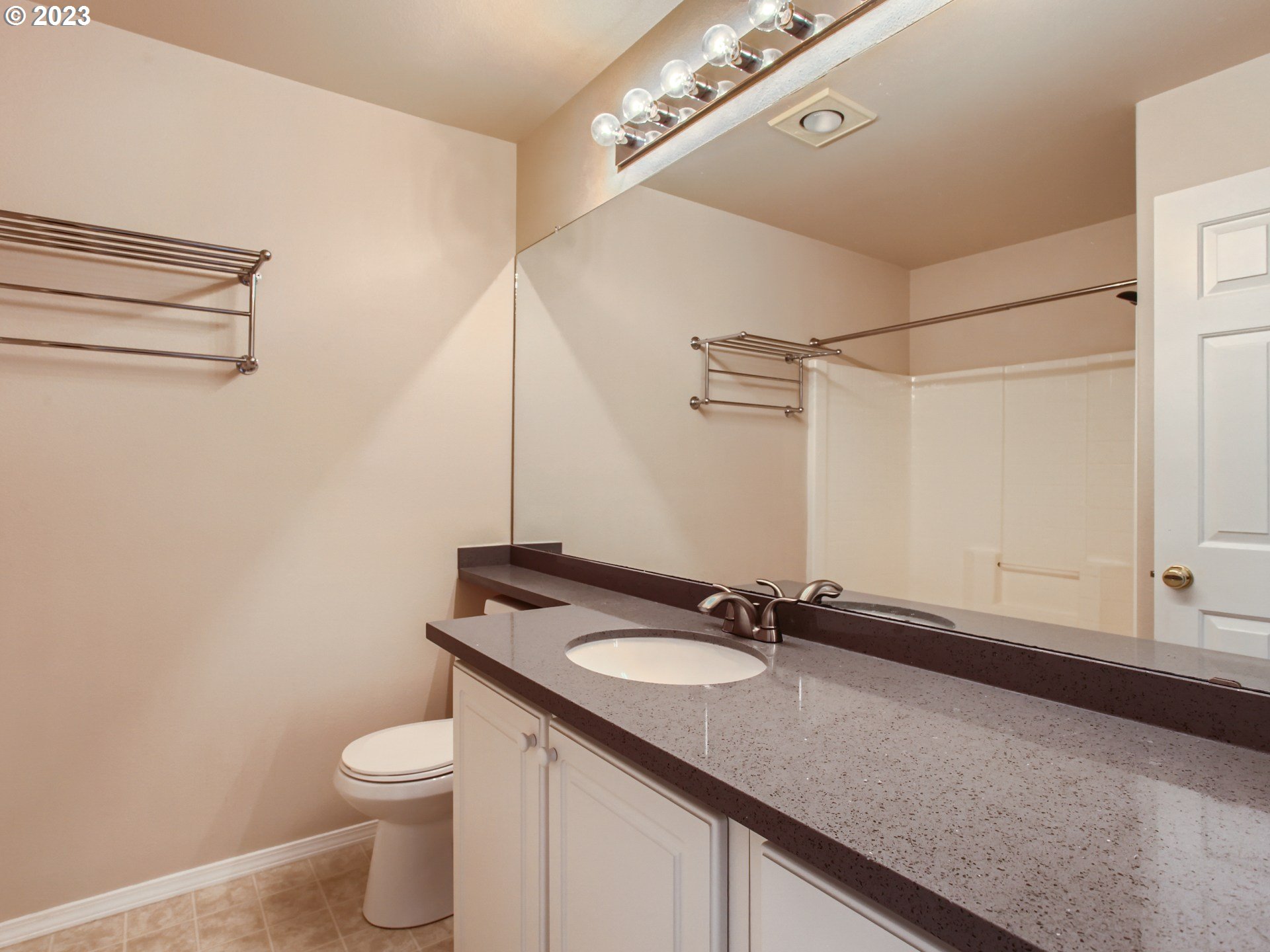 14140 Southwest Barrows Road, Unit 2 Portland, OR 97223 - Photo 16 of 30 a bathroom with a granite countertop sink and a mirror
