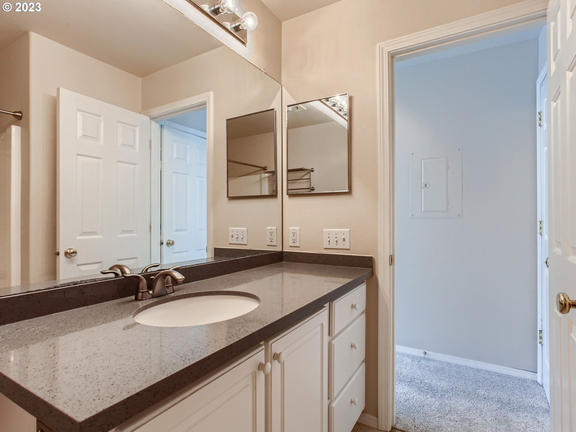 14140 Southwest Barrows Road, Unit 2 Portland, OR 97223 - Photo 17 of 30 a bathroom with a granite countertop sink and a mirror