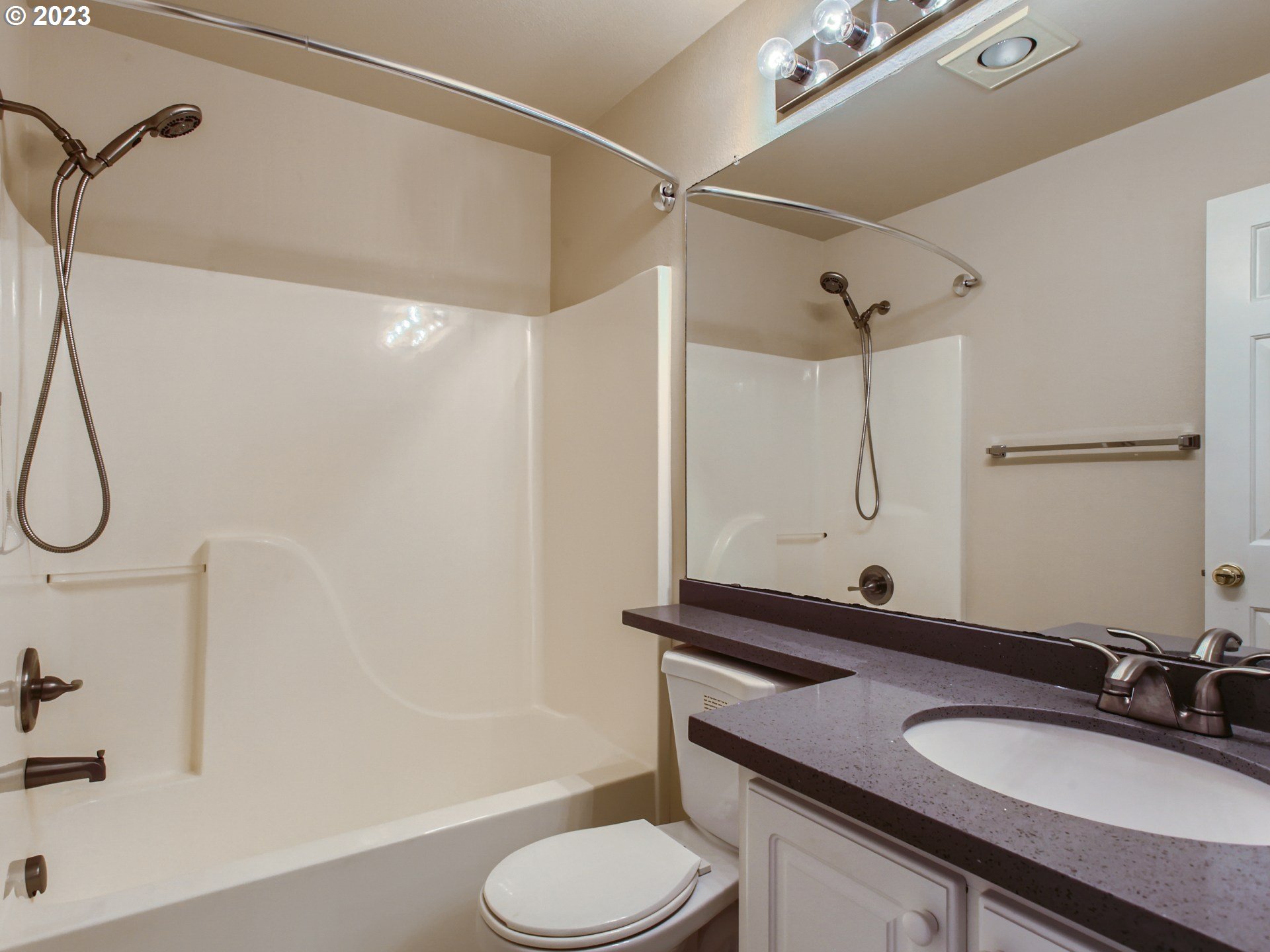 14140 Southwest Barrows Road, Unit 2 Portland, OR 97223 - Photo 20 of 30 a bathroom with a granite countertop sink toilet and shower
